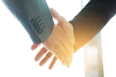 43181042 - business people shaking hands, finishing up a meeting business people shaking hands, finishing up a meeting